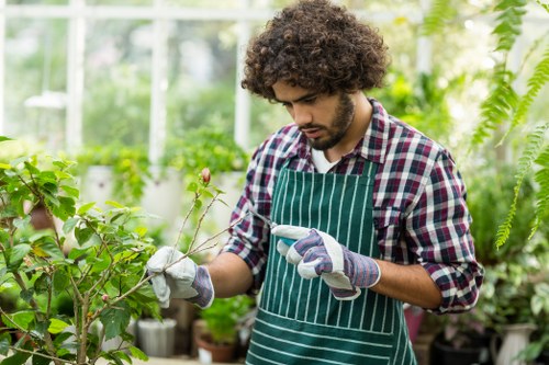 Gardener demonstrating safe pruning technique on-site